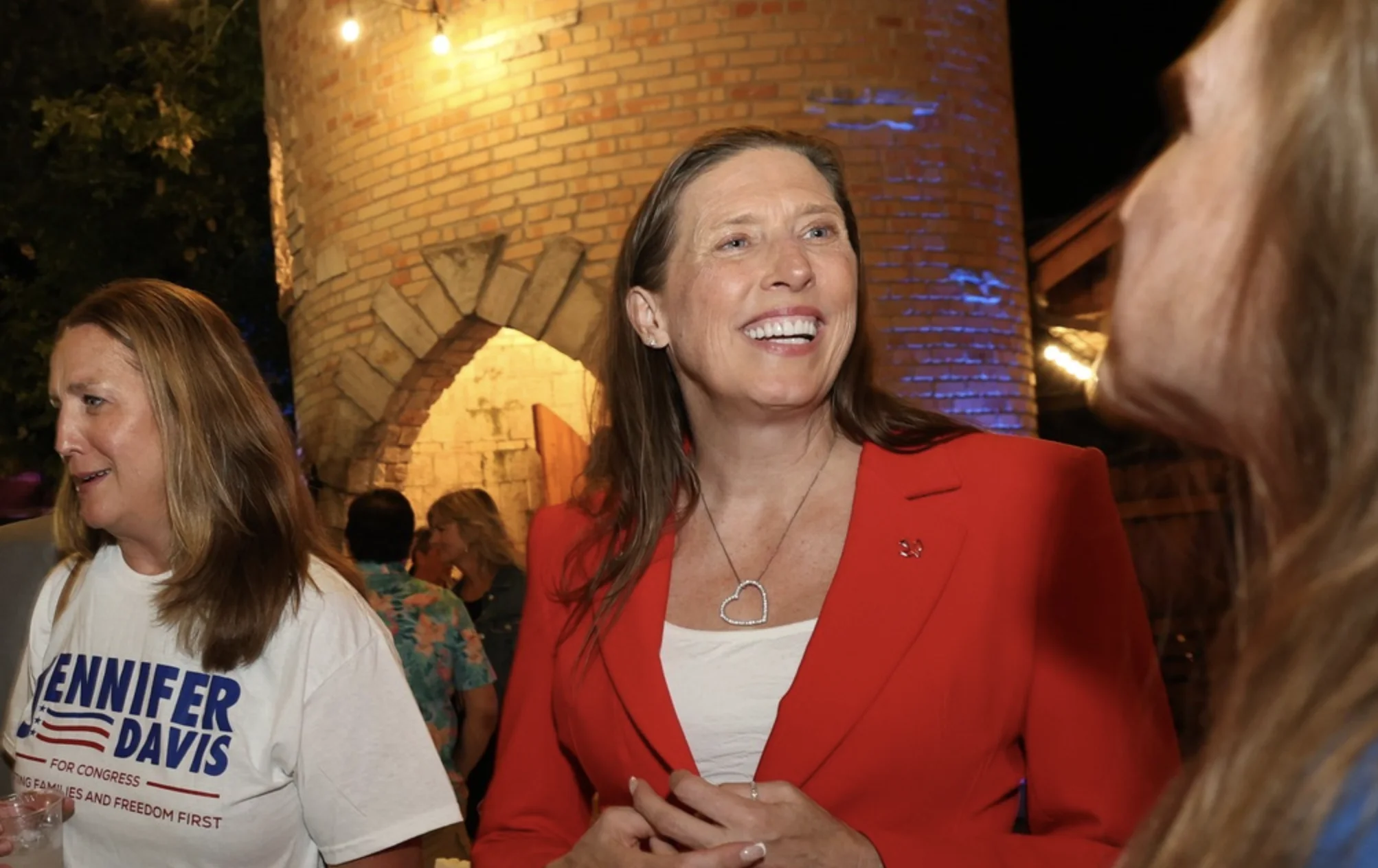 Jennifer Davis speaks with supporters at a March primary campaign event in Illinois’ 8th Congressional District.