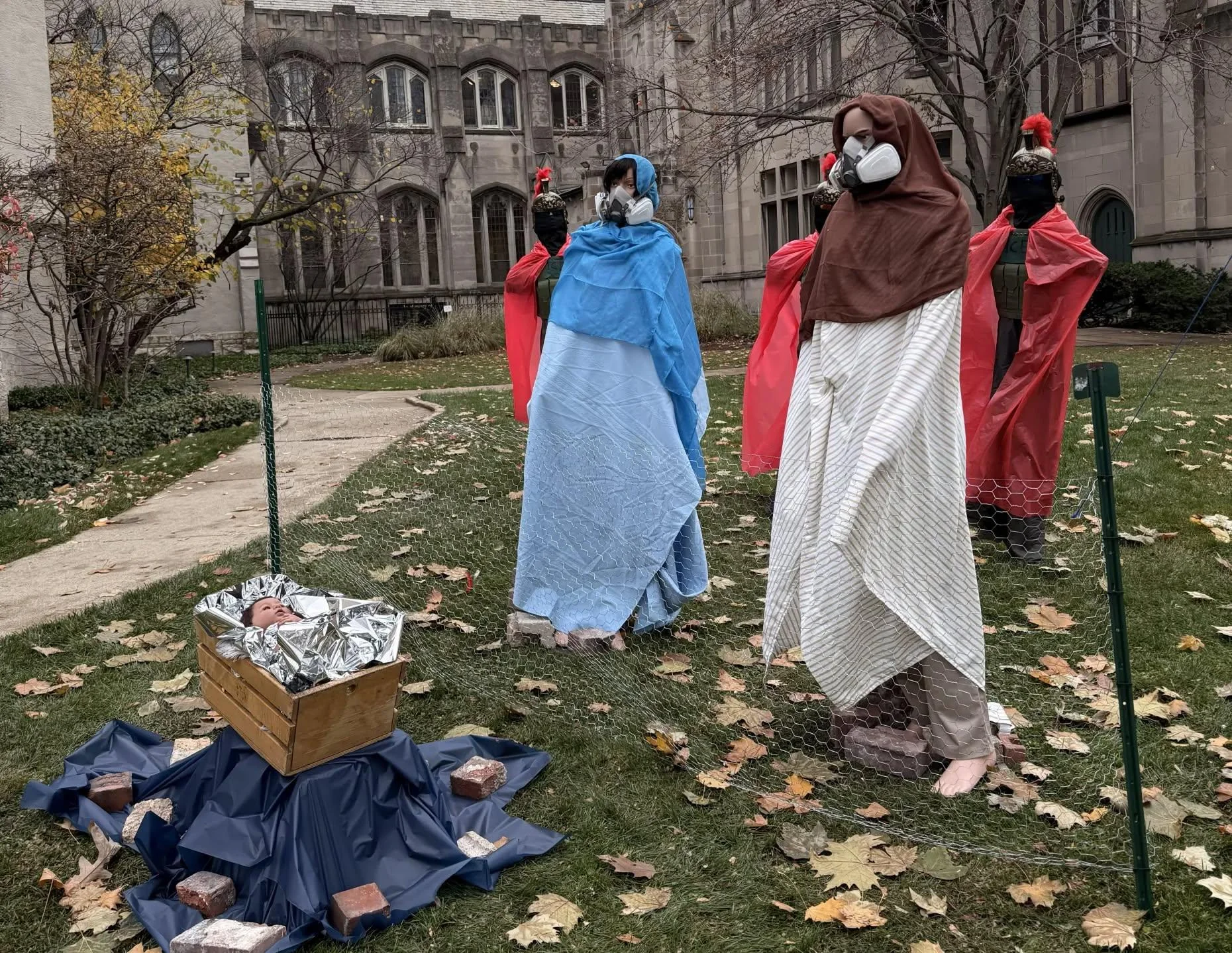 Anti-ICE Nativity at Evanston’s Lake Street Church shows Mary and Joseph in gas masks, baby Jesus with zip-tied hands; the display has faced repeated vandalism and drawn sharp criticism.