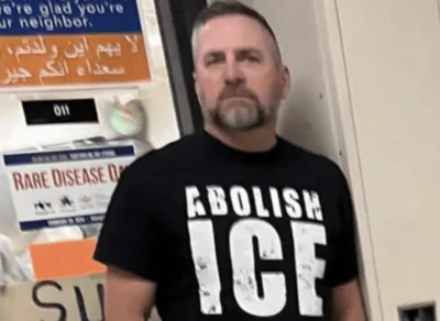 Matt Chapman, a teacher and girls’ soccer coach at Normal Community High School, pictured wearing an ‘Abolish ICE’ shirt that has sparked controversy and criticism from local community members. 